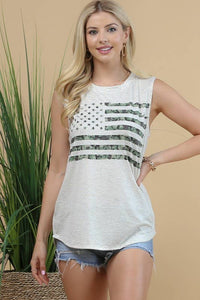 Woman wearing a sleeveless top with an American flag design against a beige background