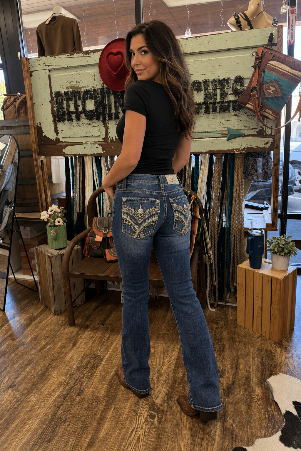 Women in store in jeans with purse and bench with decoration in store