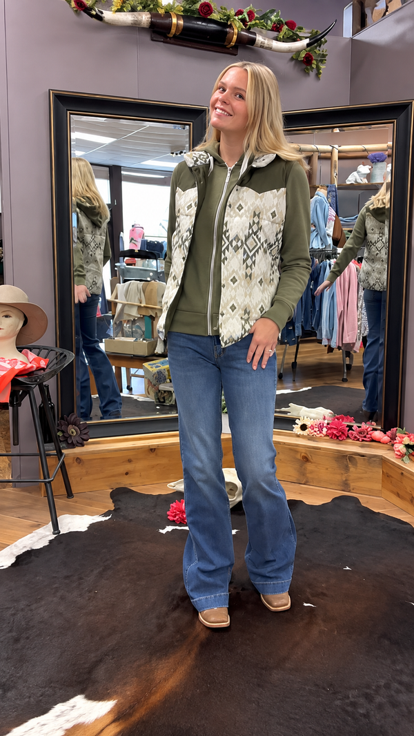 girl in olive sweatshirt and vest in store spinning in the mirror!
