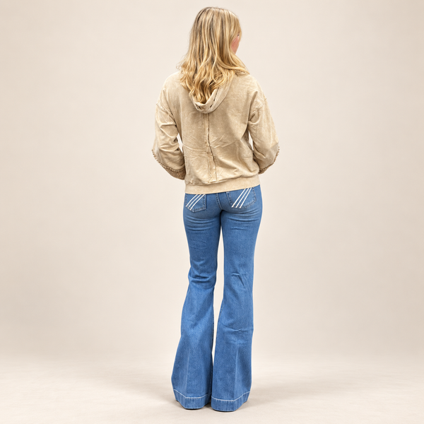 woman in cream sweater in 7 for all mankind