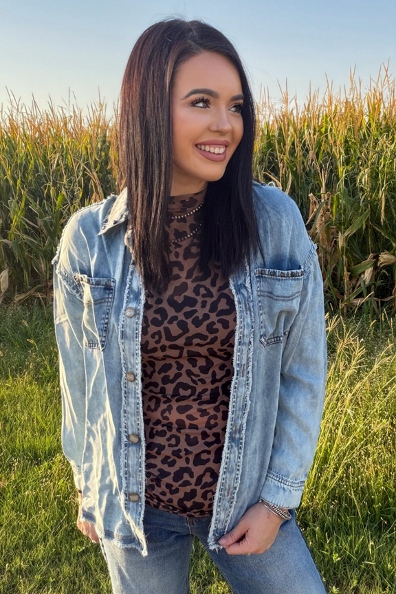 girl in tall grass wearing studded jacket