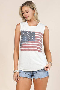 Woman wearing a sleeveless top with an American flag design on a beige background