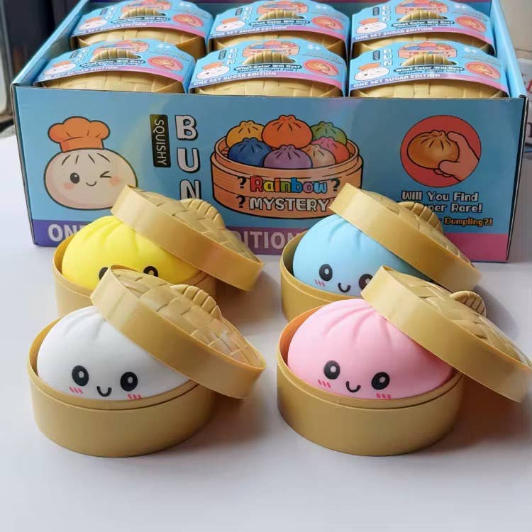 Squishy toys resembling dumplings in a box with colorful packaging.