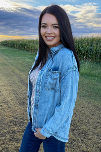 girl in field wearing studded shacket